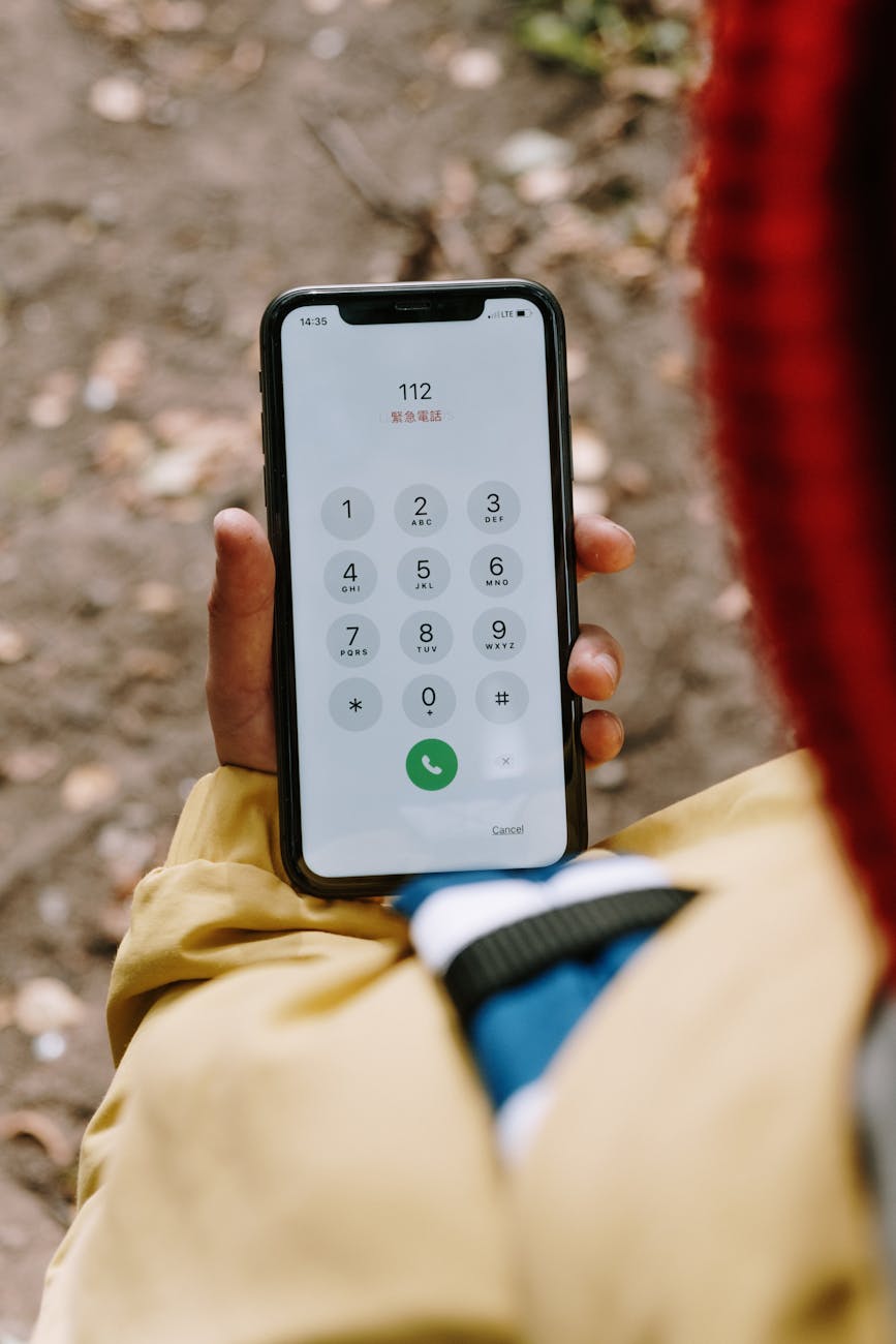 a person dialing an emergency hotline