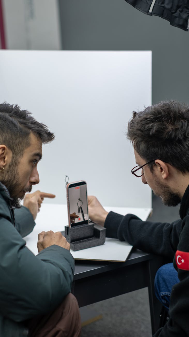 two men engaged in phone photography session